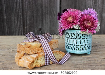 Composition with biscuits and little bouquet of flowers
