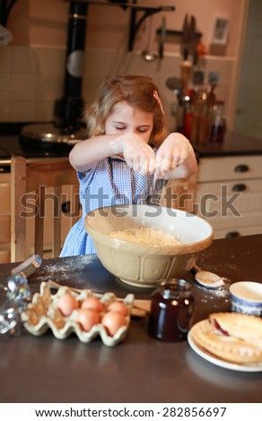 Pretty blonde girl haired mixing ingredients in a bowl