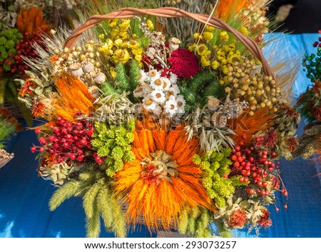 bouquet of dried flowers and colorful cereals on an occasion of the end of harvesting