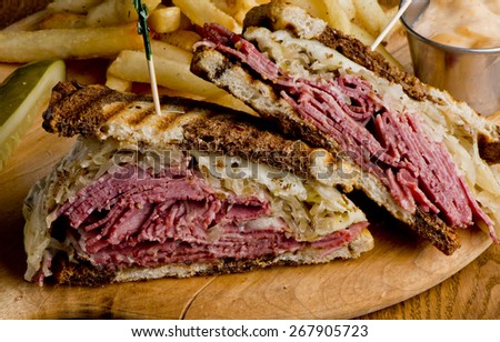 Reuben Sandwich, classic served with corned beef, Swiss cheese, sauerkraut, thousand island dressing on grilled rye bread.