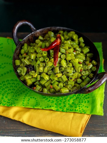 Cooked Green Beans in a Kadai is tempered with mustard seeds,urad dal and dried red chillies. It can be served as a SALAD or as a SIDE DISH or an accompaniment with Rice and Curry
