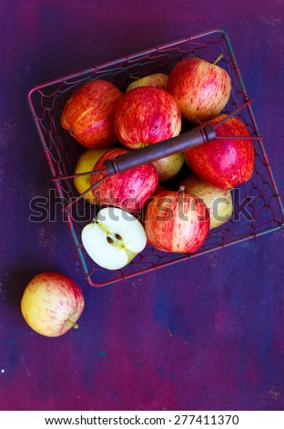 Royal Gala Apples\
Apples collected in a wire basket  , placed on a dark background