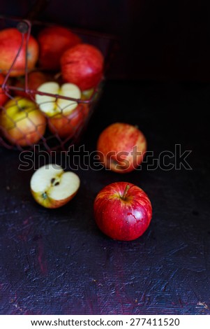 Royal Gala Apples\
Apples collected in a wire basket  , placed on a dark background