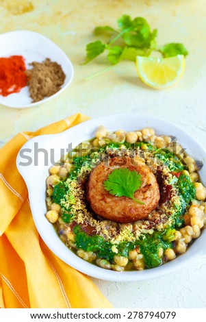 Ragda Pattice , Chat A street food from India. A potato patty is placed on a bed of dried peas gravy, topped up with chutneys, spice powders , pieces of crisps & coriander leaves