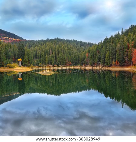 picturesque lake in the autumn forest. Mirror reflection
