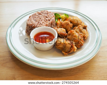 Japanese fried food chicken karaage with rice and sweet chili sauce on white plate