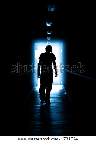 Young Man walking out of the light
