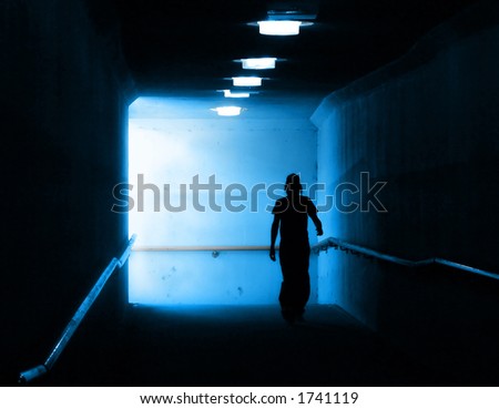 Young man walking out of the light