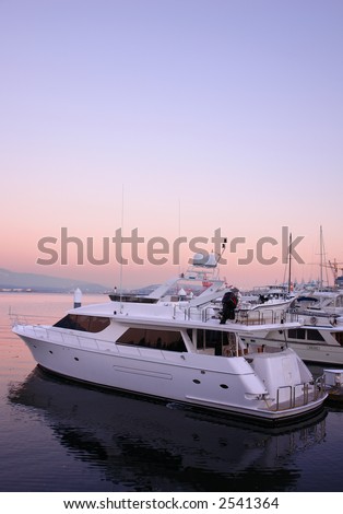 Boat in harbour with pink sunset