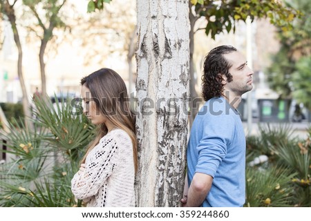 A young couple back to back after a fight