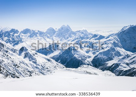 Snowy winter Greater Caucasus mountains at sunny day. View from ski slope Elbrus, Kabardino-Balkaria, Russia
