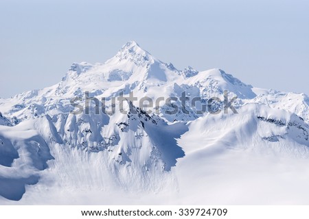 Snow covered Greater Caucasus mountains at winter sunny day. View from Elbrus slope, Kabardino-Balkaria, Russia