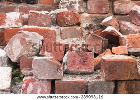 Pile of Bricks by an Old Brick Wall (taken by an old building in Saint John New Brunswick on one of the city streets)
