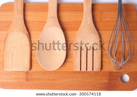Top view of wooden kitchen utensils on wood board