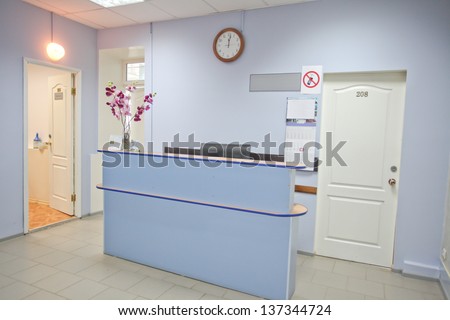 Interior of a waiting room with a table of reception