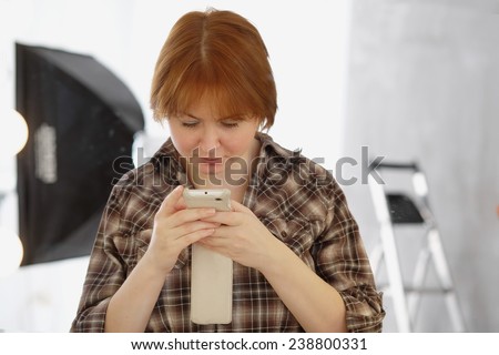 closeup woman looking at cell phone