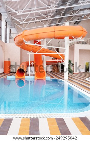 Orange waterslide, indoor pool