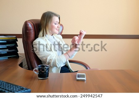 Beautiful secretary doing manicure in the office