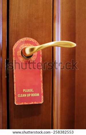 Image of a Please, Clean Up Room sign hang on door knob