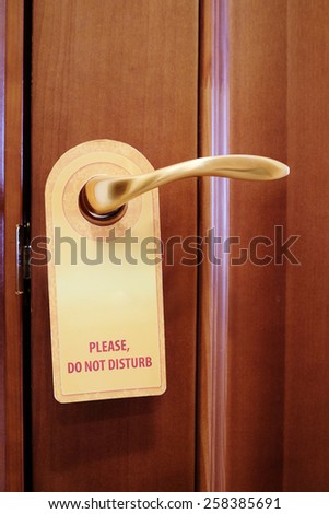 Image of a Do not disturb sign hang on door knob
