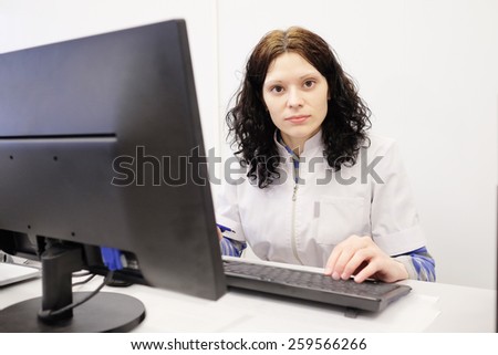 Doctor woman sitting on her office with computer set on her table