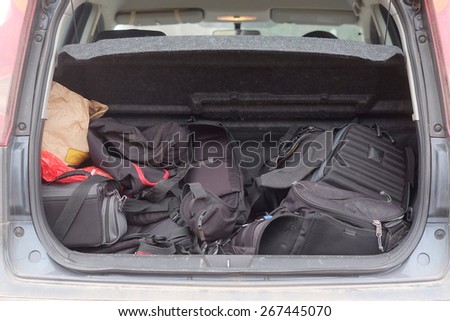 Hatchback car loaded with open trunk and luggage