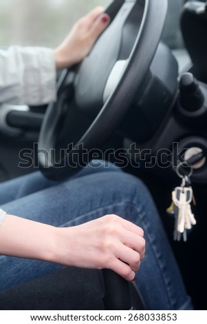 Woman manually shifting the car transmission