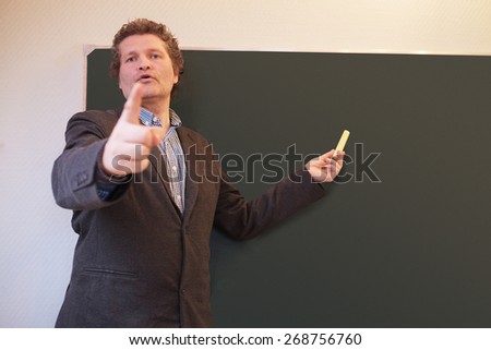 Male teacher calling on student to answer a question