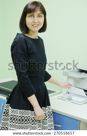 Secretary in office working on printer