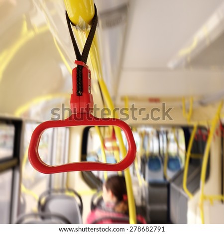Handles for standing passengers inside a bus