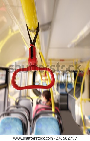 Handles for standing passengers inside a bus