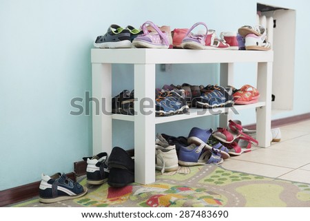 White shoe shelf with children shoes