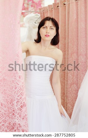 Young girl tries on a wedding dress