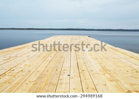 Landscape with the image of wooden jetty on Solovetsky Island in White Sea, Russia