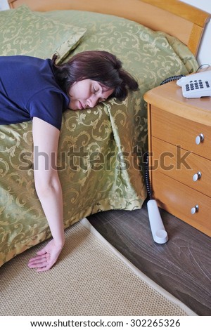 Girl lying unconscious next to the handset out