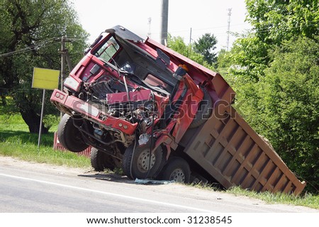 The truck  lies in a ditch after the road accident