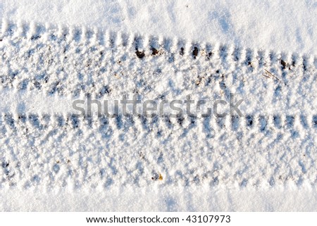 Background with the image of automobile trace under the snow