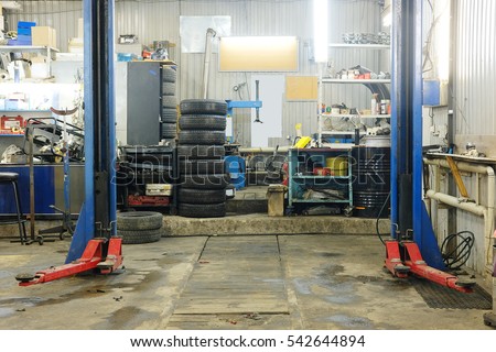 Empty workshop with a lift in a car repair station