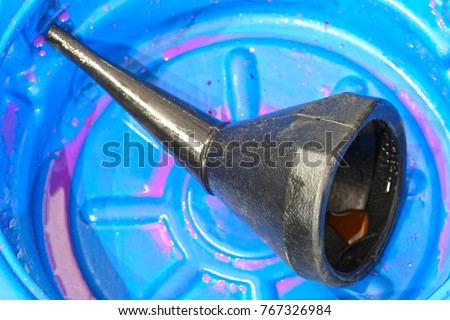 refuelling funnel in a blue plastic bowl