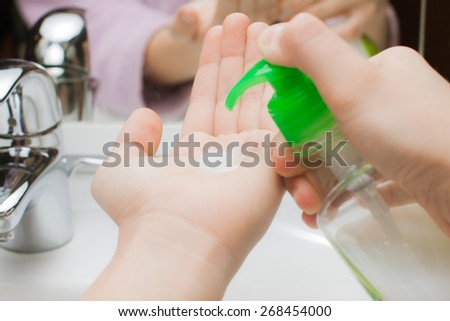 holding a bottle sanitizer