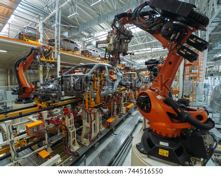 Automobile plant, welding process, modern production of cars, robot equipment, automated production line.