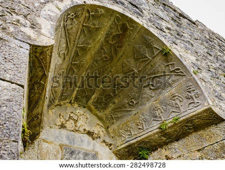 A medieval arch over a window at Aughnanure Castle in Co. Galway. The arch features some ancient stone carving and decorative detail.