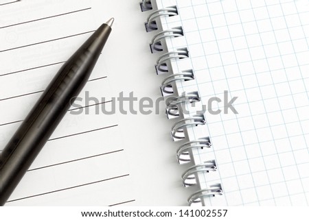 Notebook pages with pen. Isolated over white