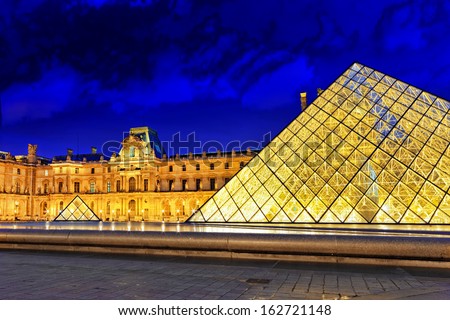 PARIS - SEPTEMBER 17. Glass pyramid and the Louvre museum on September, 17, 2013. The Louvre is the biggest museum in Paris with nearly 35,000 objects from prehistory to the 19th century .