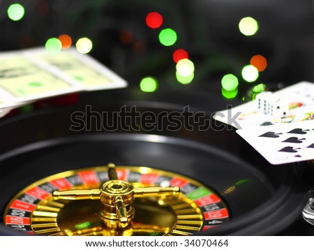 Casino  roulette, dice and playing cards. On back background -casino lights. Close-Up.