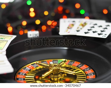 Casino  roulette, dice and playing cards. On back background -casino lights.