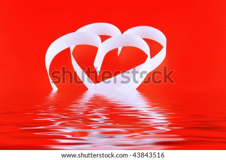 St. Valentine Day. Two hearts,on red background,  with reflection.