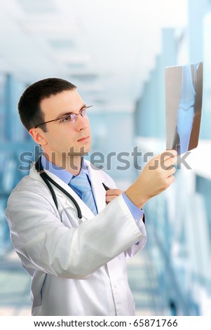 Friendly medical doctor  stand with  a x-ray image and medical pad.
