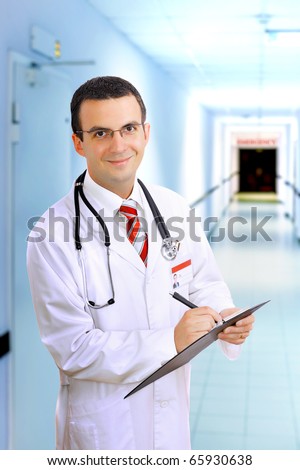 Portrait of friendly medical doctor medical pad.