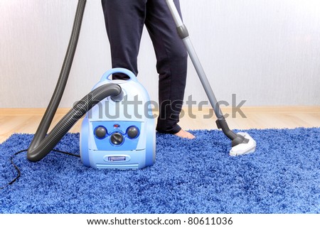 Vacuum cleaner in action  men cleaner a carpet.